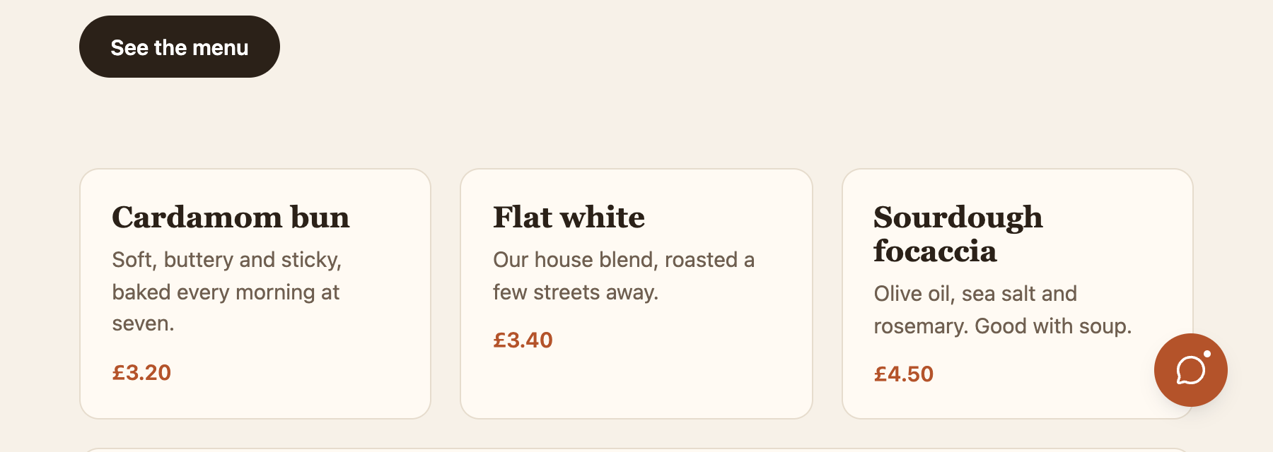 A cafe's website with the Hi Widget compact launcher: a small round button with a chat icon in the bottom right corner